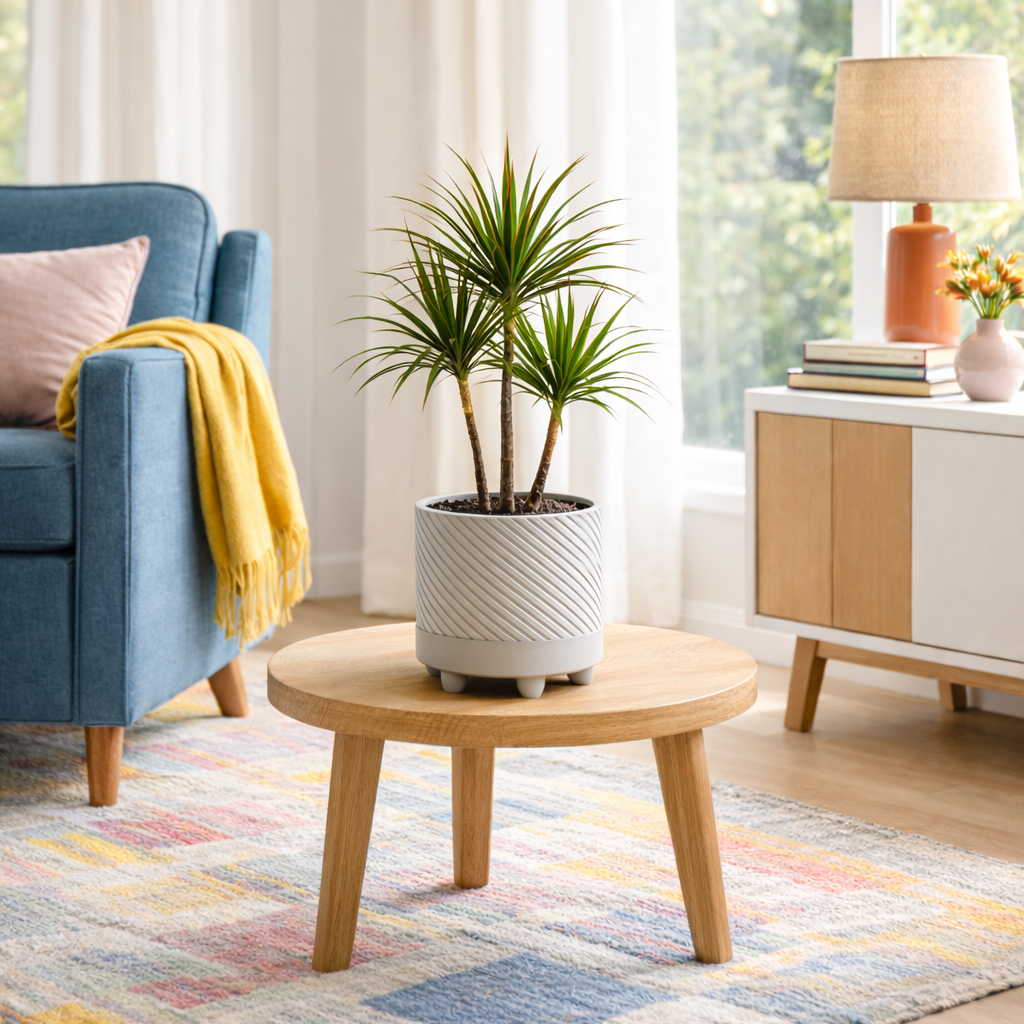 Living room with a blue armchair, wooden coffee table with a light grey plant pot that holds a plant.