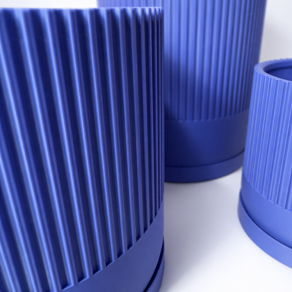 Close-up of blue cylindrical objects with ribbed texture on a white background