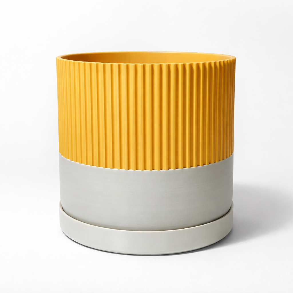 Yellow and beige ribbed planter on a white background
